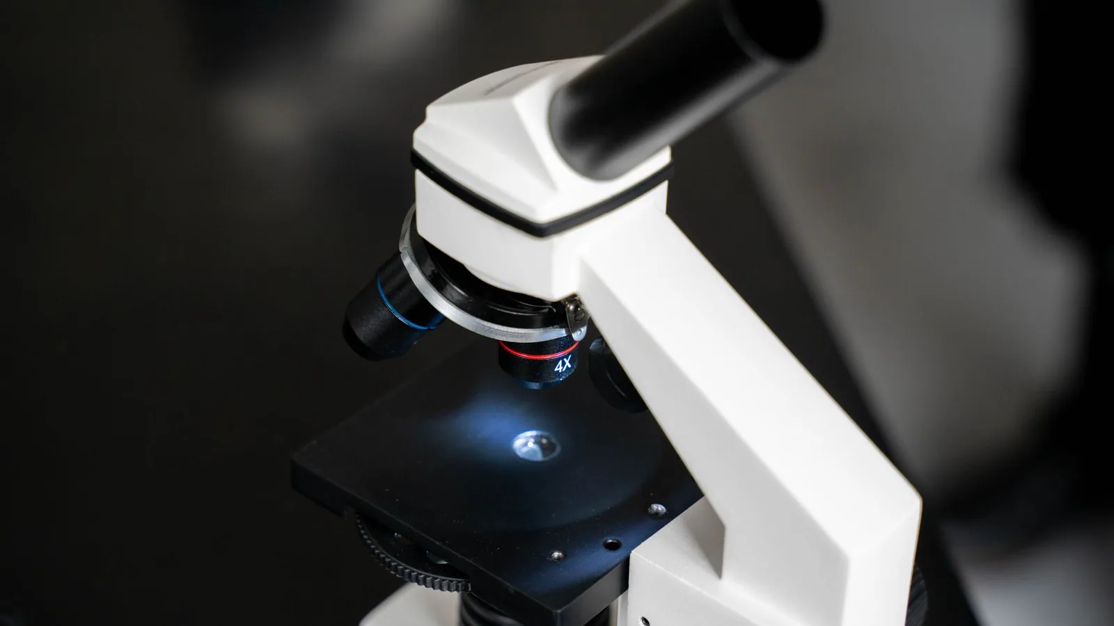 Close-up view of a laboratory microscope with selective focus, ideal for scientific use